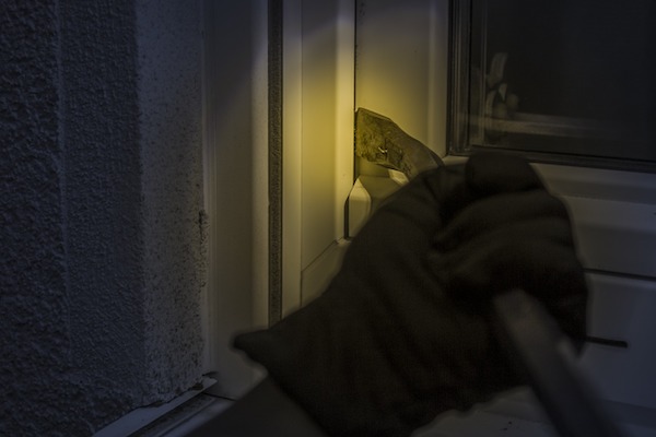 How do burglars overcome an intruder alarm system?